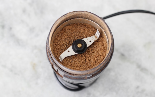 grinding coriander in the coffee grinder