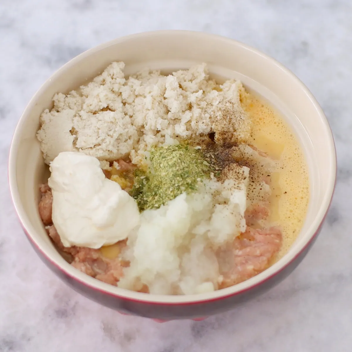 Ground meat mixture in a bowl to make chicken kotleti. 