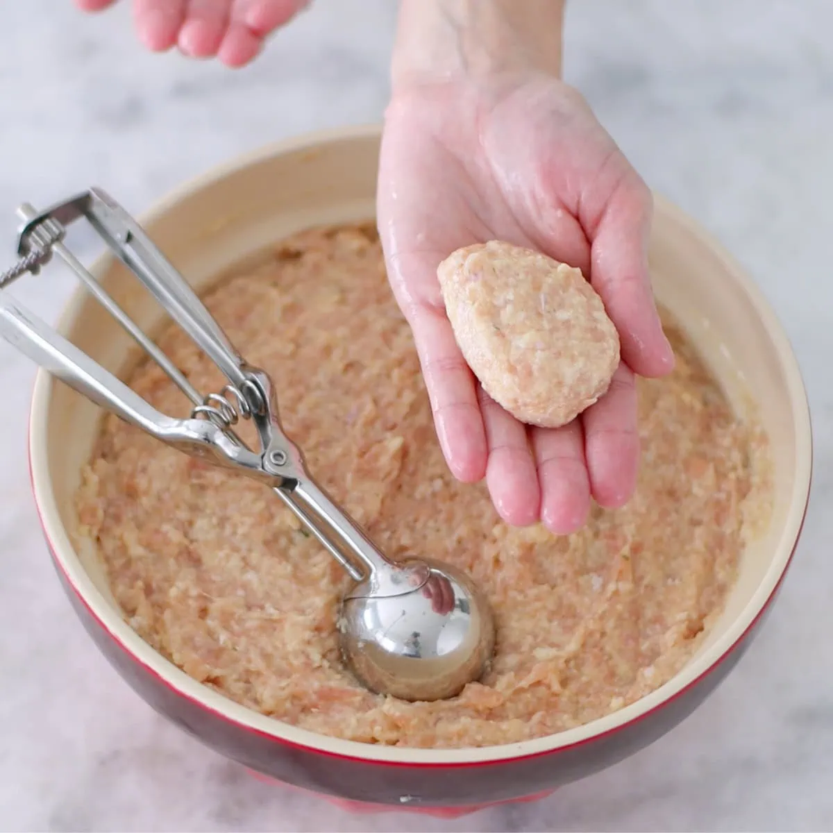 Shaping chicken kotleti, oval shaped chicken patties made with raw chicken. 