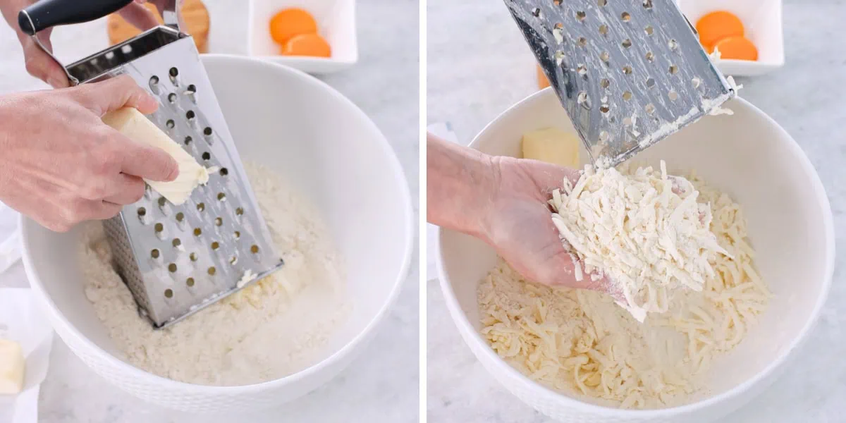 Grating butter into dry ingredients to make cookie dough for farmer's cheese cookies. 