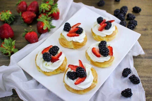 Cream Puff Pastries With Whipped Cream and Berries
