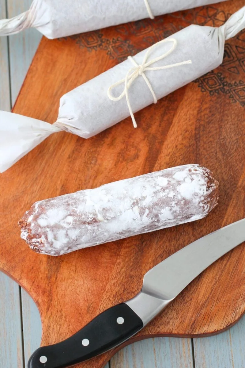 Serving the chocolate salami - cookies and chocolate wrapped in parchment, resembling salami
