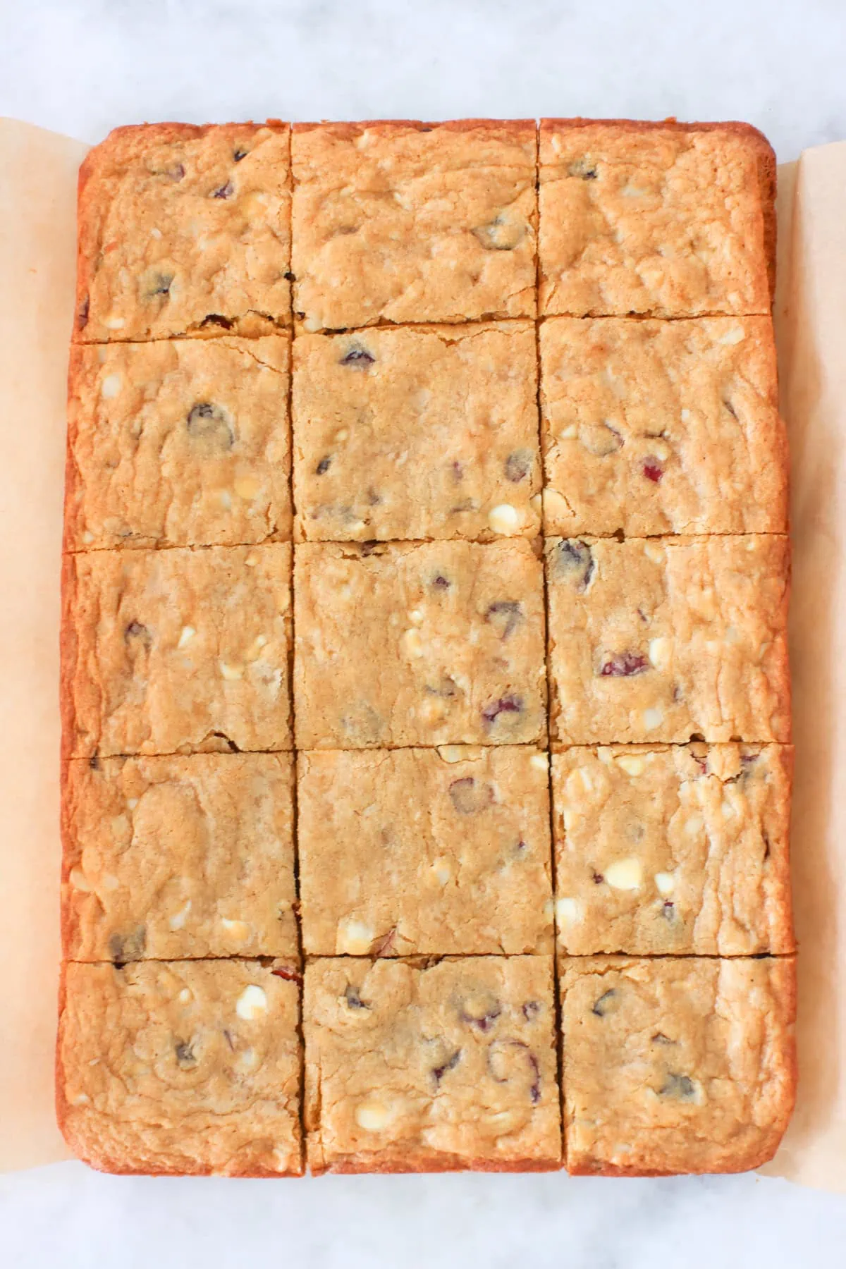 White Chocolate Macadamia Cookie Bars cut into pieces.