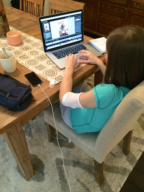 Editing a blog post. Drinking tea, of course. That pretty blue "purse" is actually my IV and pump.