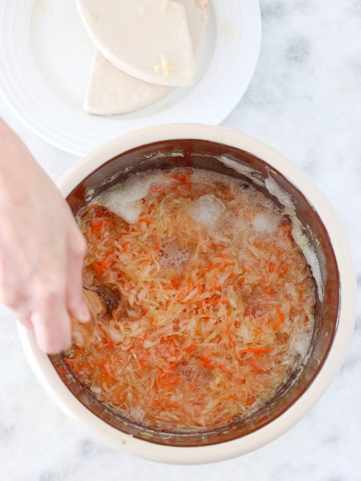 Fermenting homemade sauerkraut in a crock.