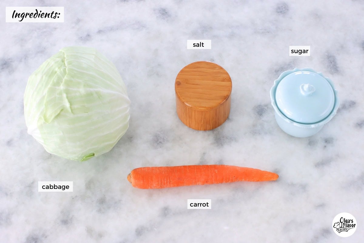 Ingredients for homemade sauerkraut on a marble countertop.