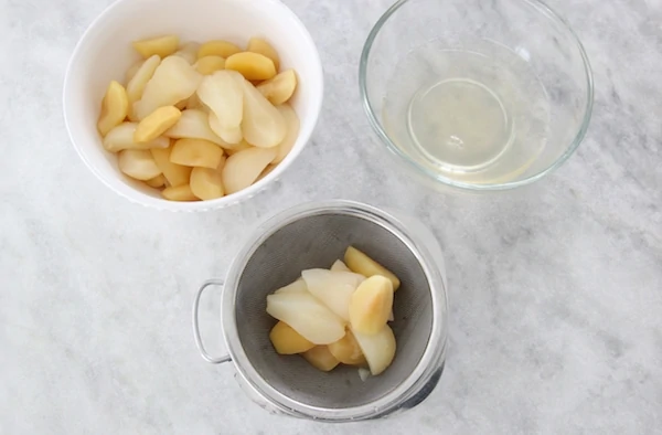 Straining cooked apples and pears for kompot and applesauce