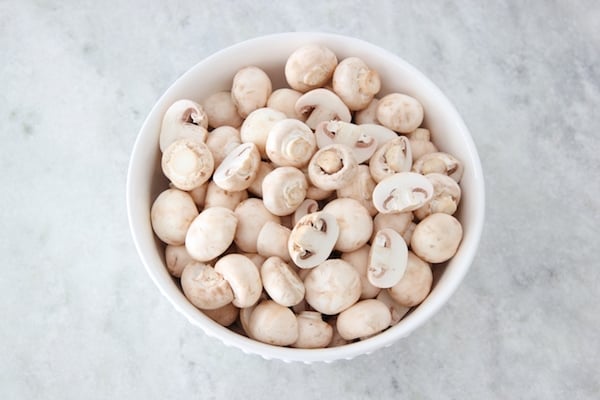 A bowl full of fresh white button mushrooms