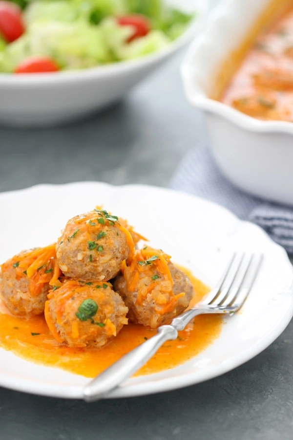 Porcupine Meatballs - beef and pork meatballs with rice and baked in a creamy tomato and vegetable sauce.
