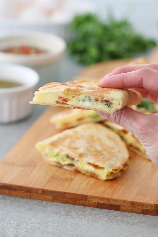 Breakfast Quesadillas filled with eggs, cheese, bacon and green onions. 