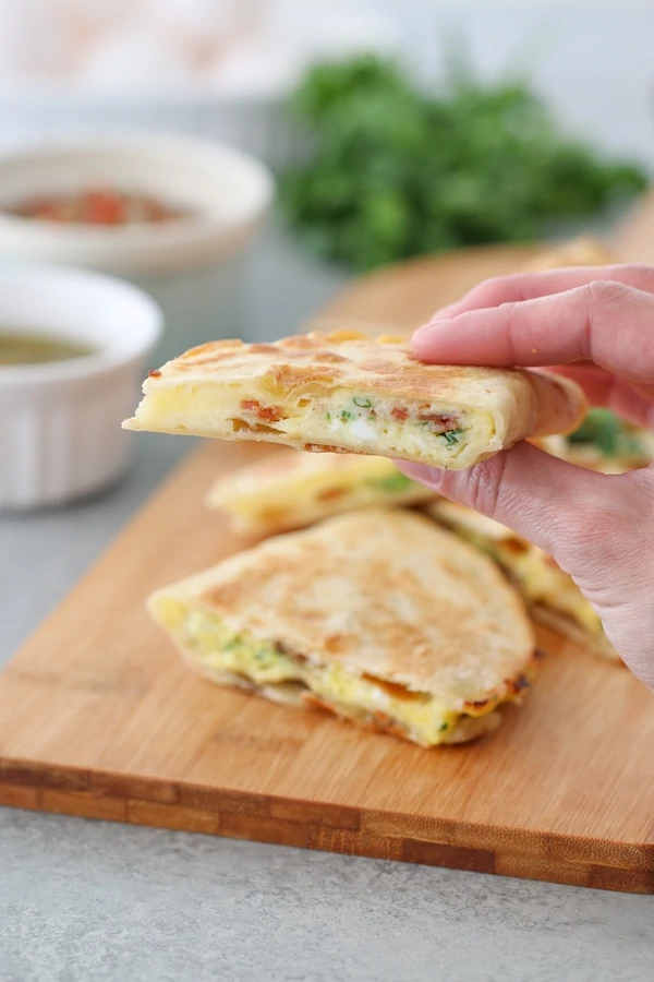Breakfast Quesadillas filled with eggs, cheese, bacon and green onions.