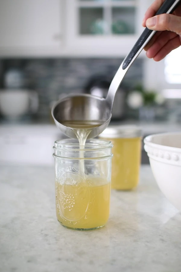 Instant Pot Chicken Broth poured into a jar