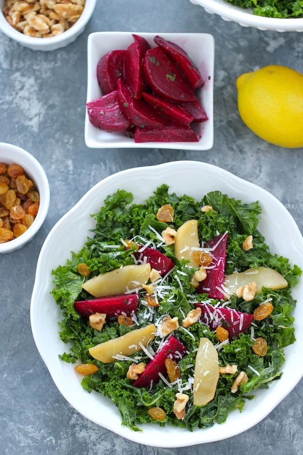 Kale Salad With curly kale, roasted beets, cooked honey apples, walnuts, golden raisins, Parmesan cheese and vinaigrette