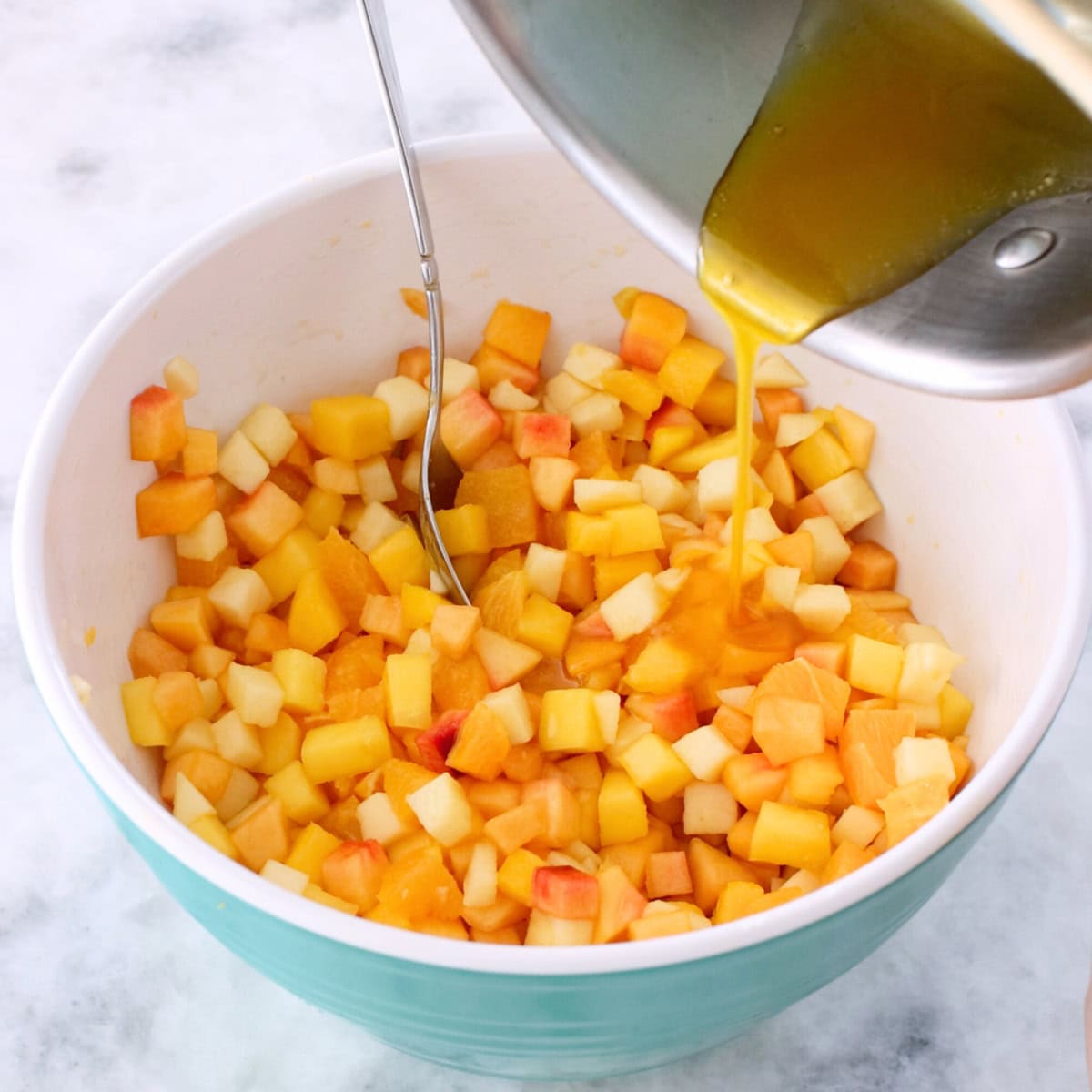Make ahead fruit salad in a bowl, pouring orange lemon syrup/glaze over the fruit.