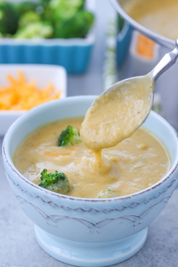 A bowl of healthy broccoli, vegetable and cheese soup. 