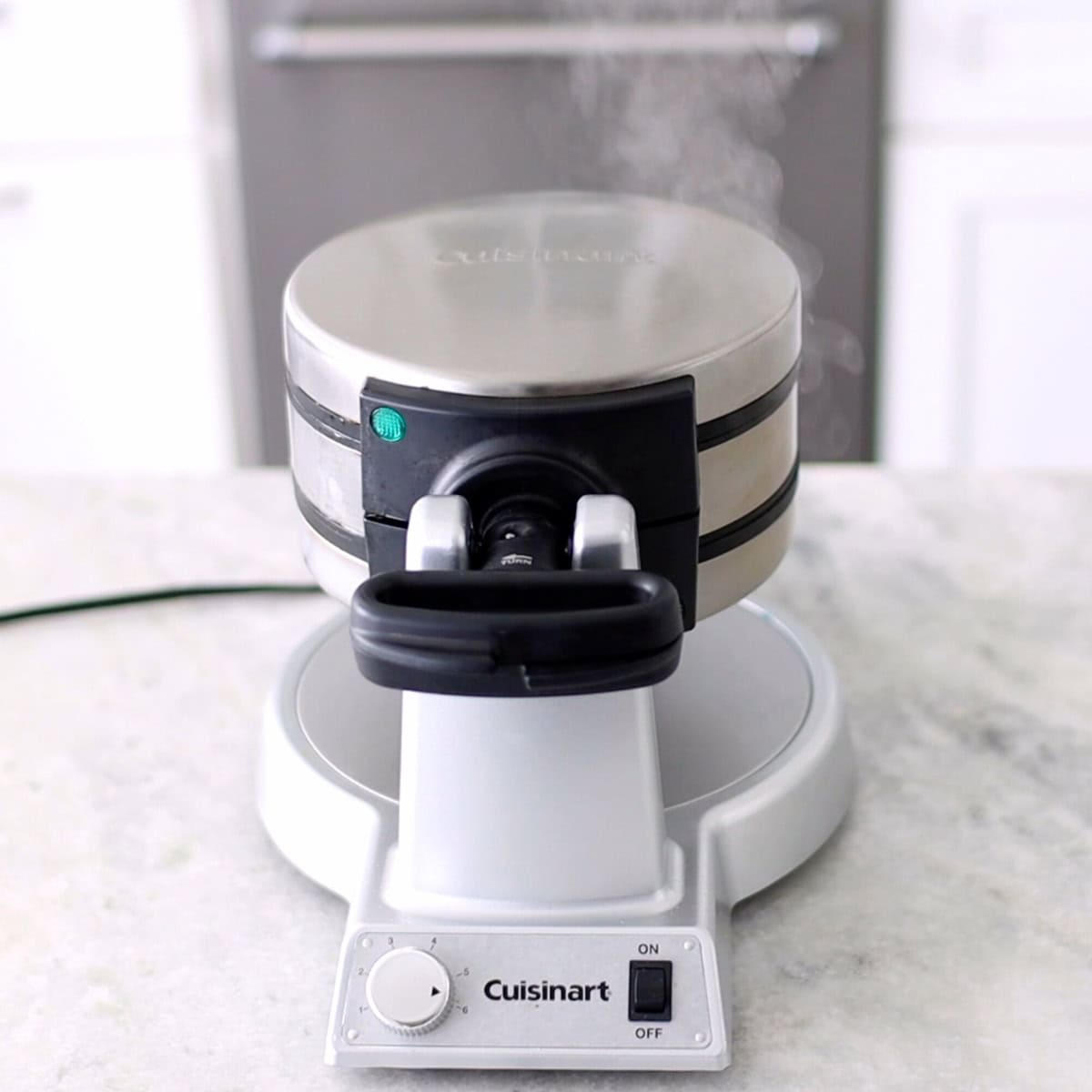 Preheating waffle maker to make potato waffles. 