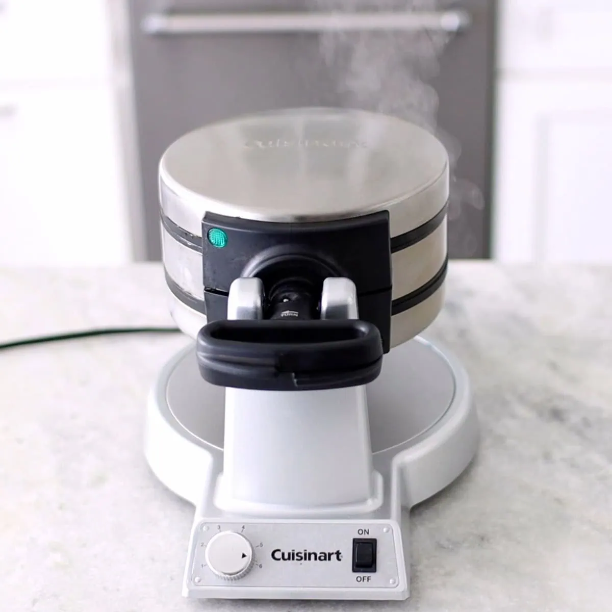 Preheating waffle maker to make potato waffles. 