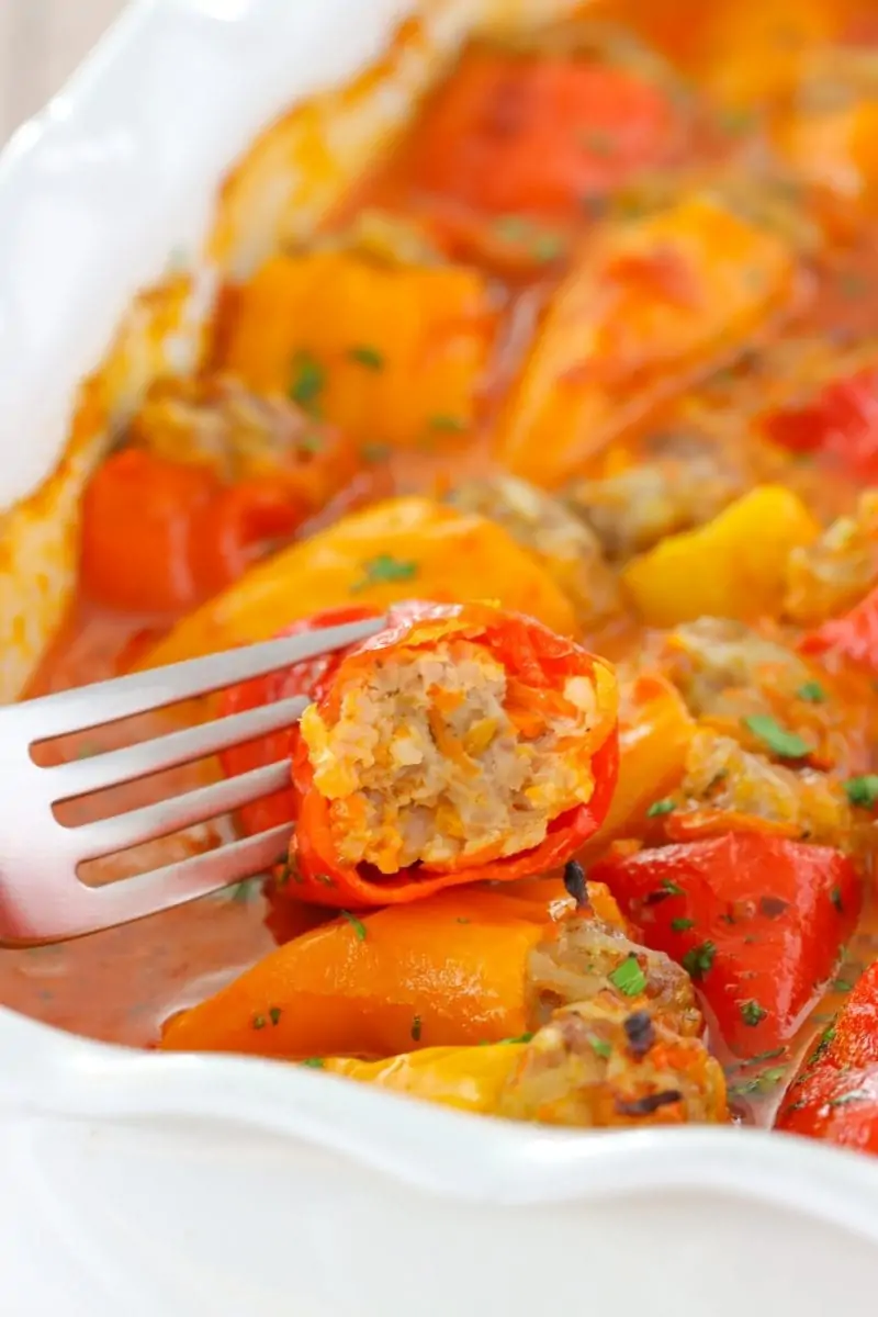 Juicy stuffed mini peppers with a ground meat and rice stuffing and baked in a creamy tomato sauce