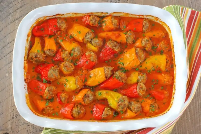 Stuffed mini peppers with tomato sauce in a baking dish