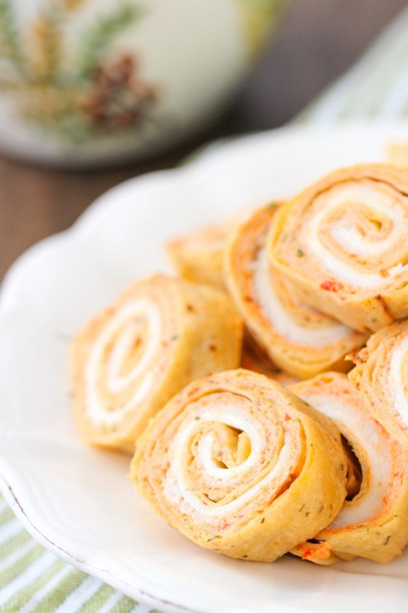 Turkey Pinwheels - an appetizer made with tortillas, cream cheese roasted veggie spread, turkey and cheese. All of this is rolled up and then sliced into pinwheels. 