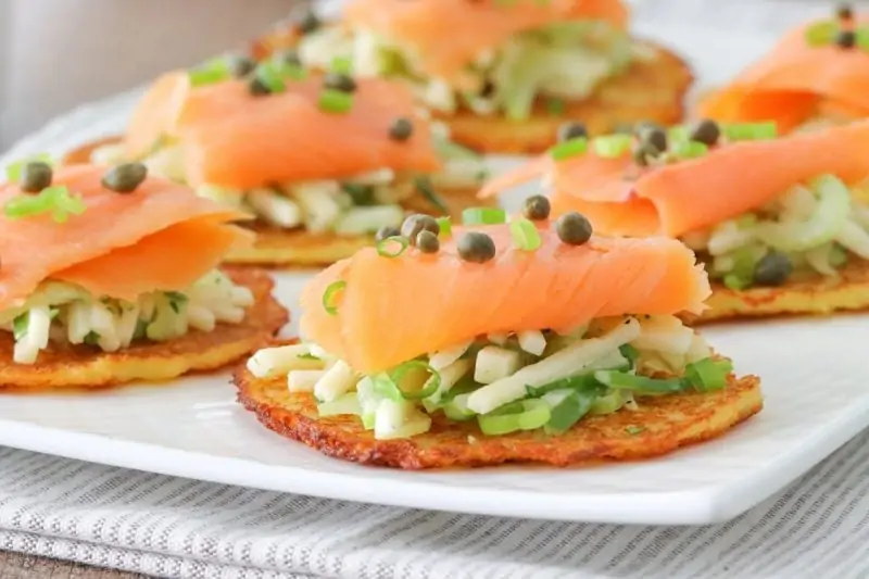 Potato pancakes with smoked salmon, apple celery slaw, capers and green onions. 