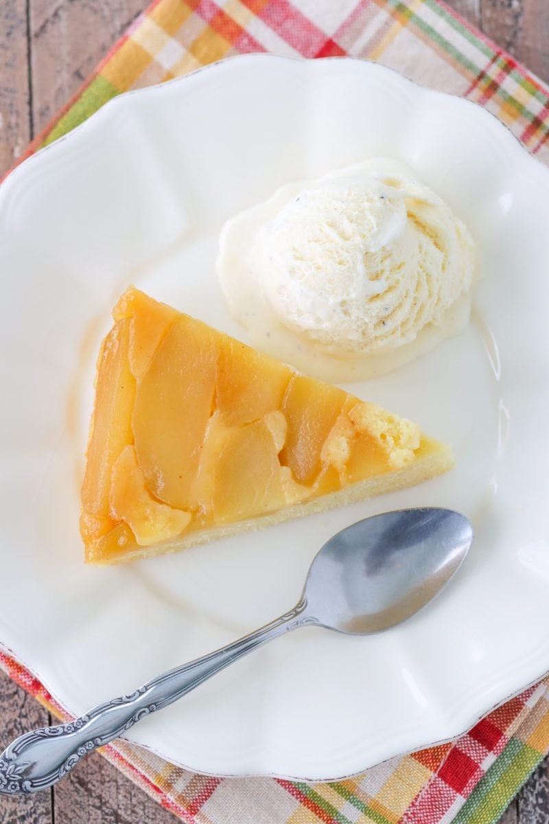 A slice of Apple Upside Down Cake with a scoop of vanilla ice cream