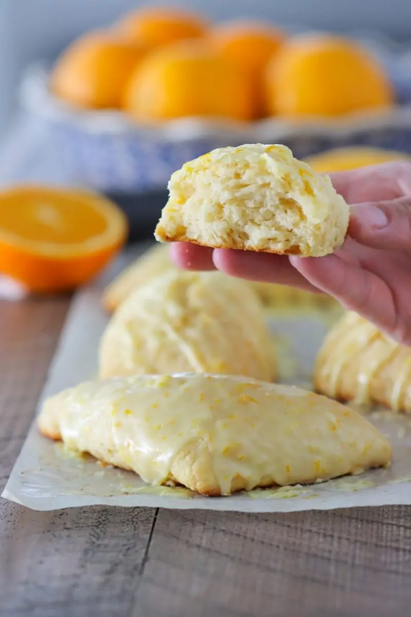 A close up of an Orange Scone with orange glaze.