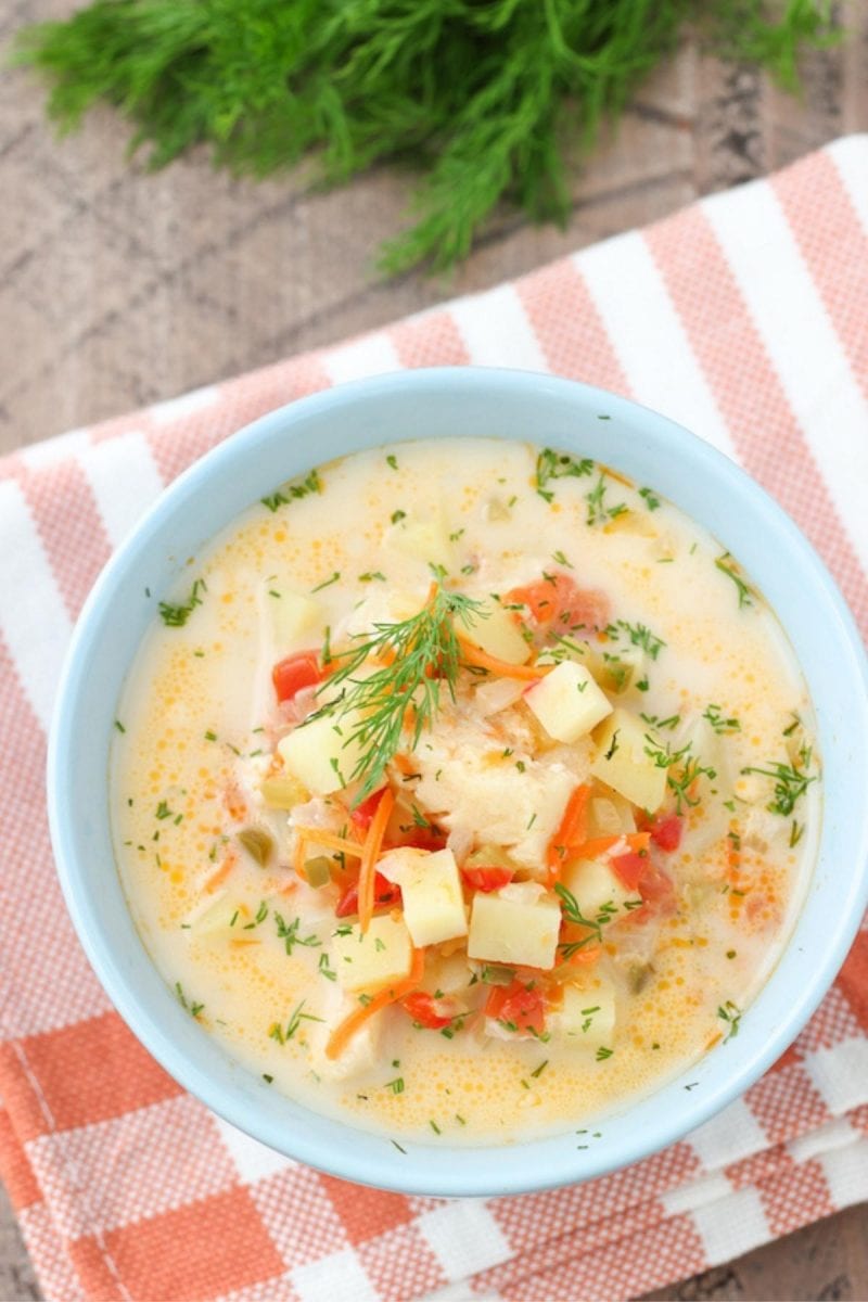Potato and cod soup with vegetables, cream and fresh herbs. 