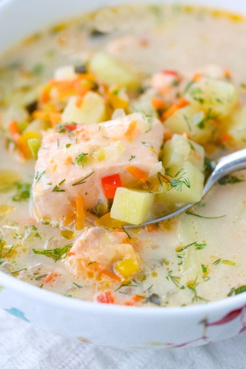 A bowl of salmon and potato soup.