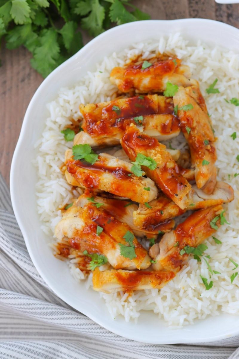 Baked Teriyaki Chicken served over rice with fresh herbs. Juicy, tender chicken with crispy skin and a homemade teriyaki sauce. 