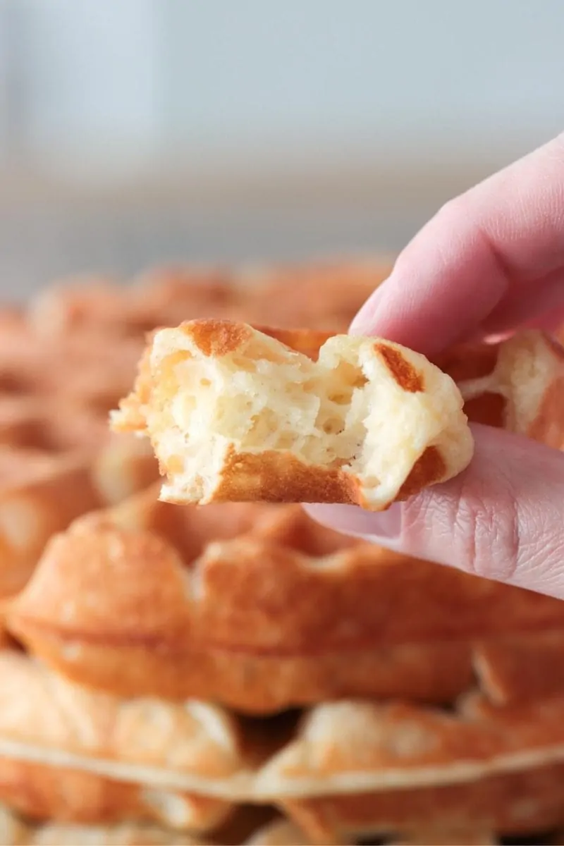 A closeup picture of sourdough waffles - so airy and tender on the inside, golden and crisp on the outside.  