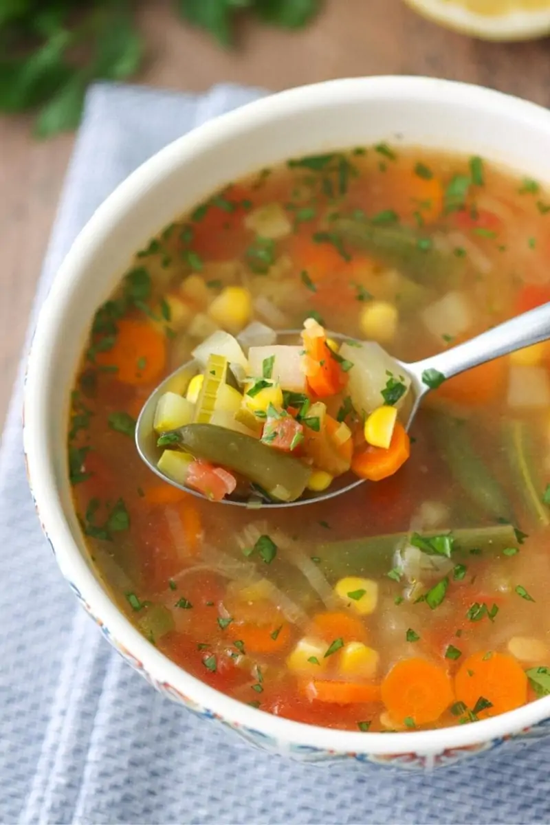 Homemade Vegetable Soup, made with leeks, garlic, carrots, celery, potatoes, green beans, tomatoes, zucchini and corn. 