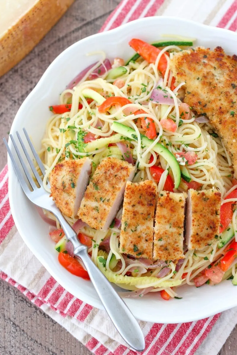 Breaded Chicken Scampi Pasta with vegetables and a light cream and white wine sauce. 