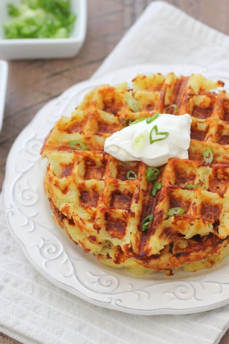 Potato Waffles made from raw potatoes and served with sour cream.