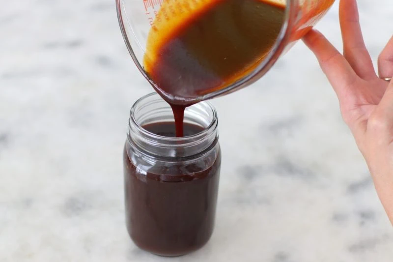 Homemade Sweet Barbecue Sauce poured into a mason jar