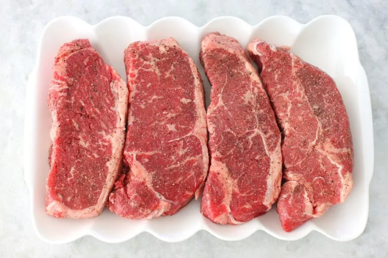 Choosing the best steaks, thick with lots of marbling
(steaks on a plate)