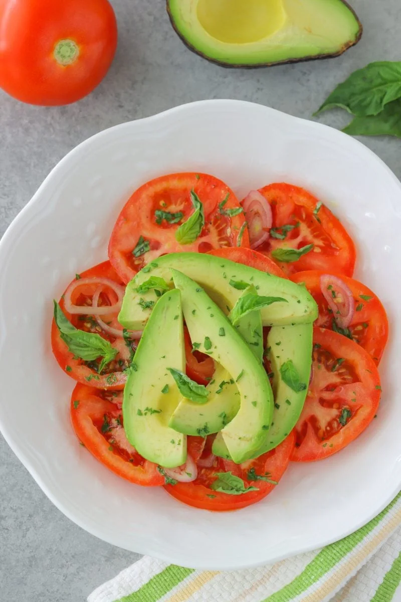 Tomato and Avocado Salad with a simple vinaigrette, shallot and fresh parsley and basil