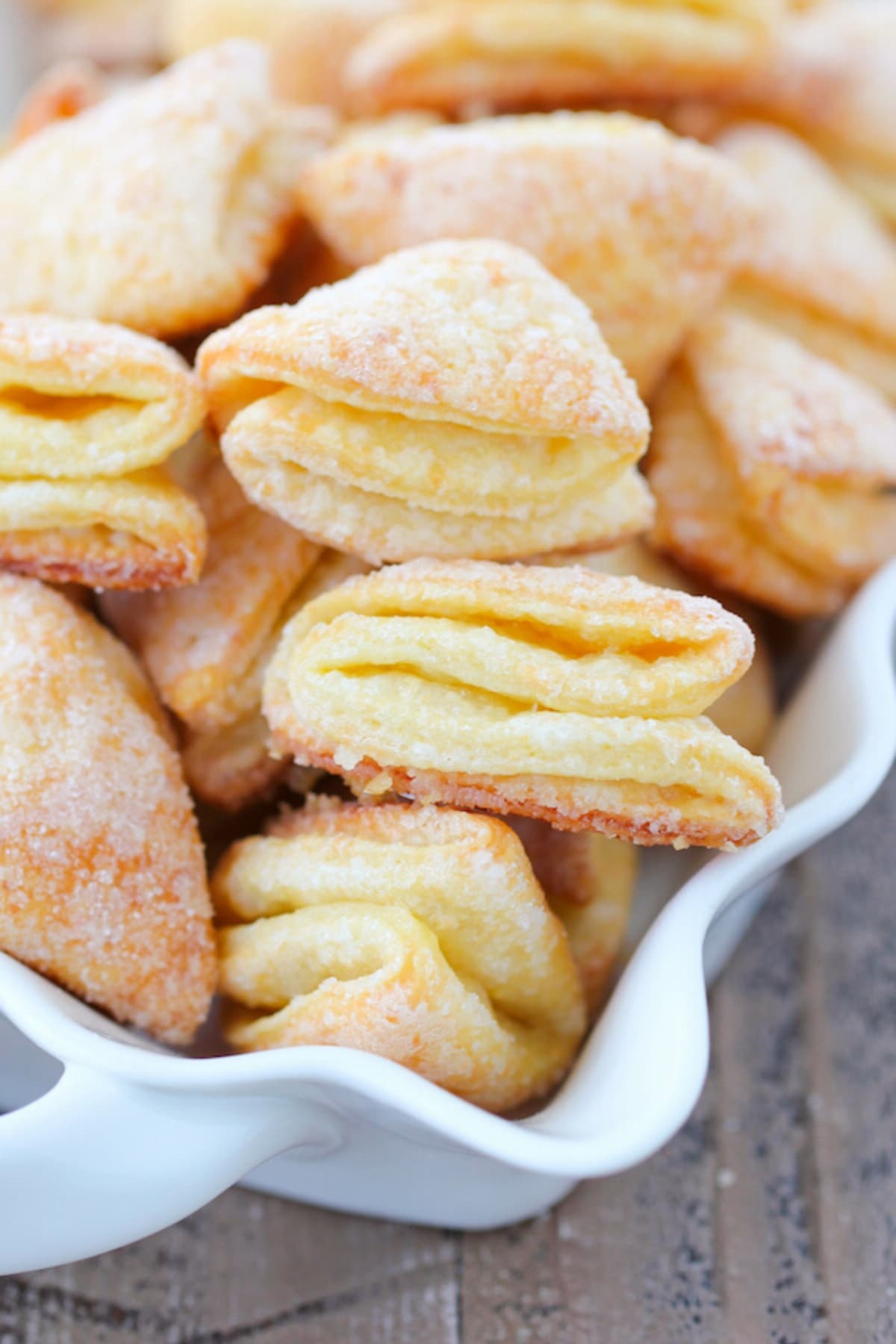 Close up of Farmer's cheese cookies, aka Geese Feet, they are Golden and crisp on the outside, flaky and tender on the inside.
