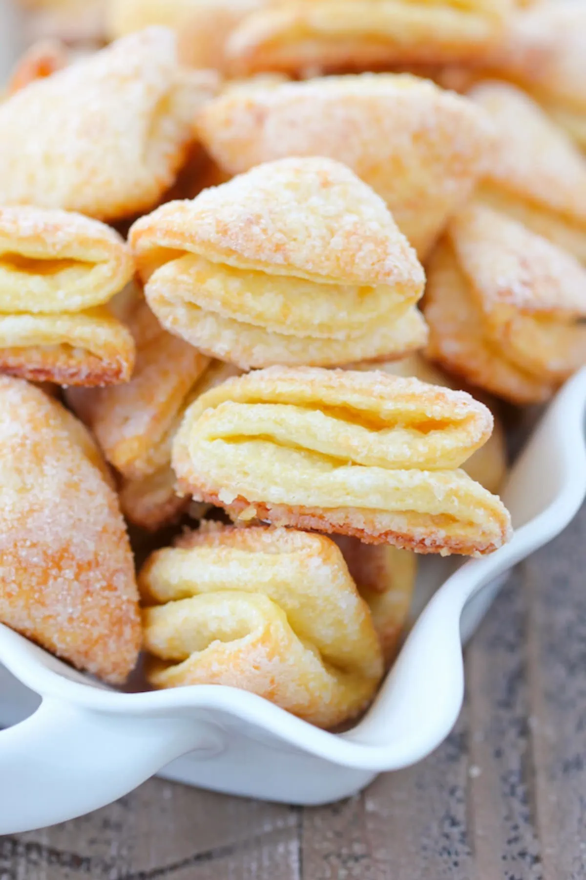 Close up of Farmer's cheese cookies, aka Geese Feet, they are Golden and crisp on the outside, flaky and tender on the inside.
