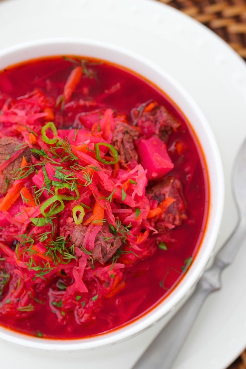 Beet Borsch - hearty and delicious, served with dill and green onions.