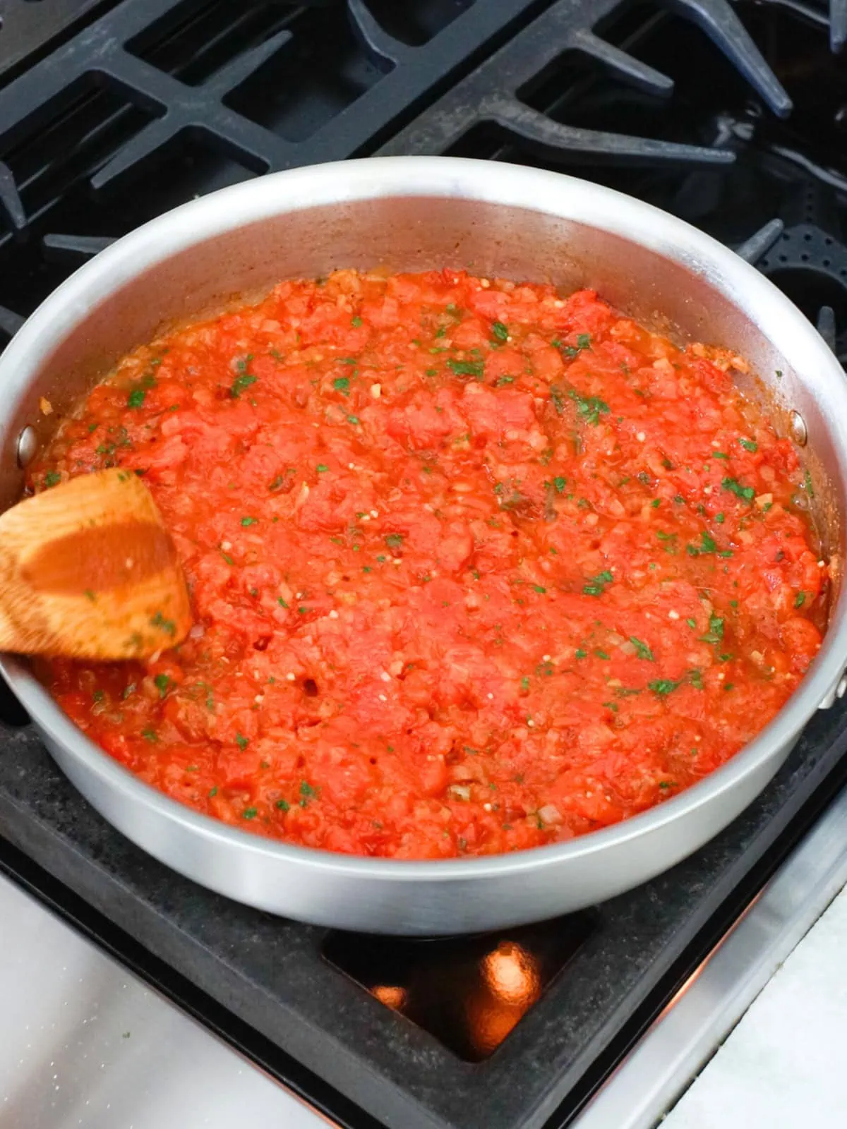 Shakshuka with fresh tomatoes cooked in a deep skillet. 